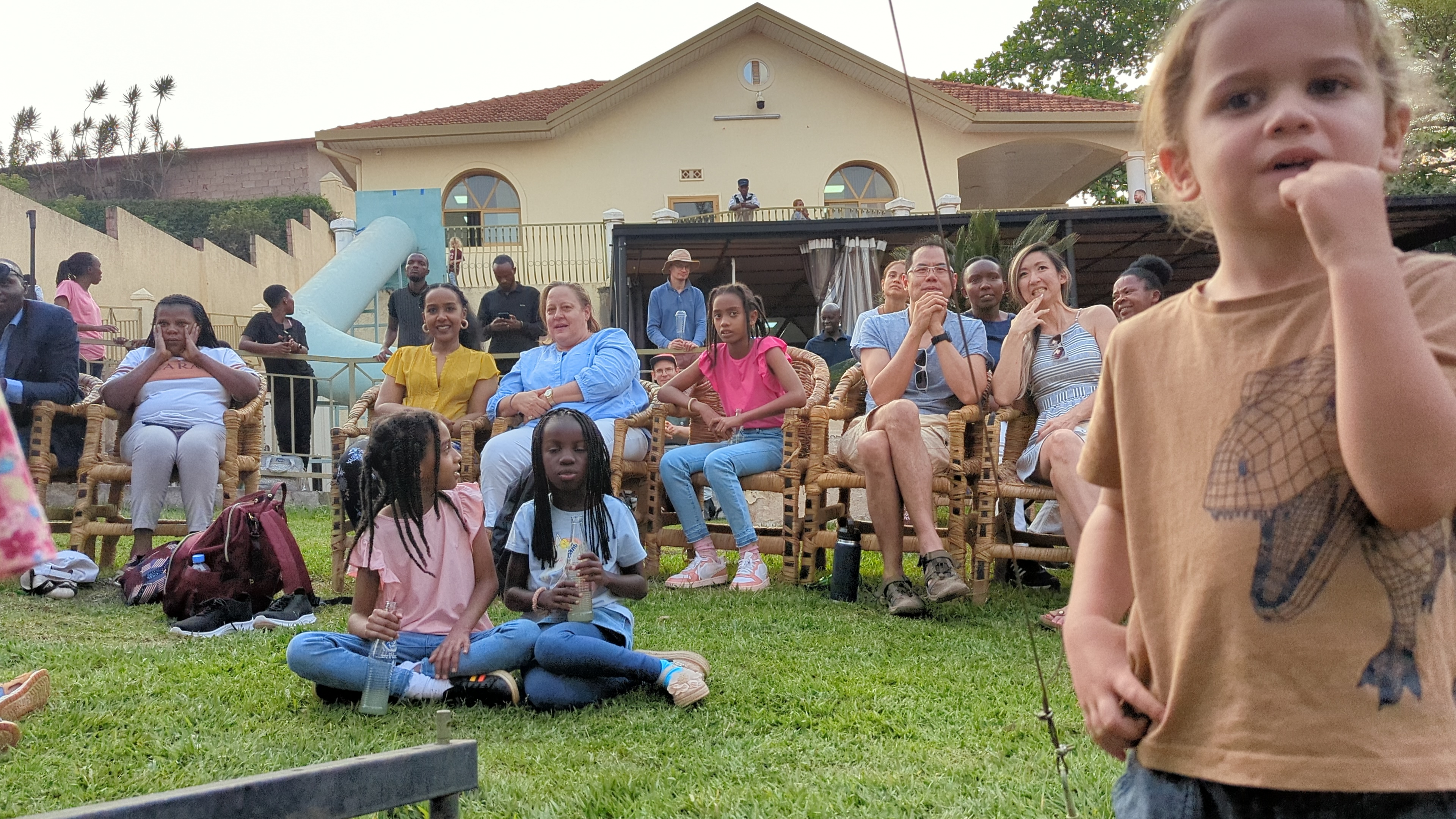 Community members watching a programme activity
